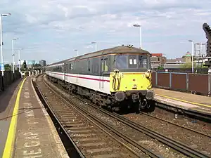 3rd rail electrification. This system carries +750V on the outer third rail, and traction current returns via the running rails which are nominally 0V.