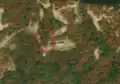 3/8 Communication tower (man_made=tower and tower:type=communication), with an antenna and a small building, on top of a mountain (Maxar satellite imagery).