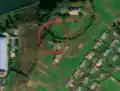 5/8 Communication tower (man_made=tower and tower:type=communication), with an antenna casting a shadow and a small building, in a valley (Maxar satellite imagery).