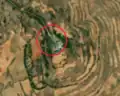 7/8 Communication tower (man_made=tower and tower:type=communication), with an antenna and a small building, on top of a plain (Maxar satellite imagery).