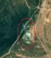1/8 Communication tower (man_made=tower and tower:type=communication), with antenna and small building, on top a mountain near the town of Hamhung (Esri satellite imagery).