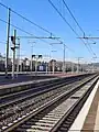Italian railway departure indicator lit with main signal on background