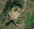 2/6 Farmyard (landuse=farmyard) surrounded by a fence with hay stacks, connected to the road (Maxar satellite imagery).