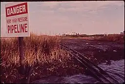 PIPELINES FROM A NATURAL GAS INSTALLATION RUN THROUGH RATTLESNAKE BAYOU