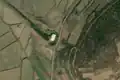 1/4 Pumping station (man_made=pumping_station) isolated on a stream near a road (Maxar satellite imagery).