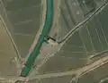 4/4 Pumping station (man_made=pumping_station) connecting a watercourse to the canal system (Maxar satellite imagery).