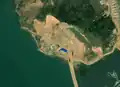 3/4 Mining area (landuse=quarry) on an island more difficult to recognize, but which breaks with the vegetation on the upper part of the image (Maxar satellite imagery).