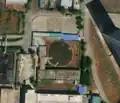 1/5 Covered reservoir (man_made=reservoir_covered) round-shaped in the middle of a dense urban area in Pyongyang (Maxar satellite imagery).