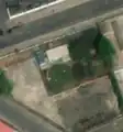 4/5 Covered reservoir (man_made=reservoir_covered) round-shaped, along the road, in the middle of a dense urban area in Pyongyang (Maxar satellite imagery).