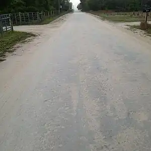 surface=compacted - surface=unpaved may mean this kind of surface