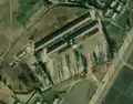 1/4 Classic school form (amenity=school) consisting of two long buildings close together (building=school) and a large schoolyard in front (Maxar satellite imagery).
