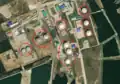 2/4 Storage tank (man_made=storage_tank) along a water area (Maxar satellite imagery).