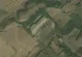3/4 Substation (power=substation) with many poles around and small shadows in its enclosure (Maxar satellite imagery).