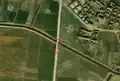 2/6 Stone pillars (barrier=tank_trap) along the road before a bridge (Maxar satellite imagery).