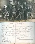 Studio photo of 7 Red Cossacks (4 seated, 3 standing)