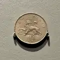 10 New Pence coin stamped "2 SHILLING".