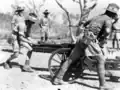 Members of the 2/2nd Tank Attack Regiment removing the breech block during a demonstration of stripping a 75mm Pack Howitzer.