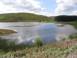 A lake surrounded by hills