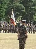 Colonel Launois in front of the regimental colors of the 2e RIMa.