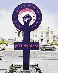 Image 1An Antimonumenta, installed in Mexico City on International Women's Day 2019, as photographed the day after. The circle part says "In Mexico 9 women are murdered daily" and the cross part says "Not one more!" On the opposite side, the Antimonumenta reads "We demand a national gender alert", and in the central part "No + Femicides" (from International Women's Day)