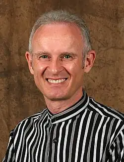 Arthur Goldstuck, mna in a striped collarless shirt