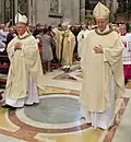 Bishop Malvestiti, just ordained, blessing the people. Behind him, bishops Beschi, left, and Merisi, right.