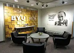 Lobby with writing on left wall, photograph on right wall