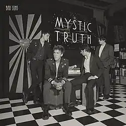 A black-and-white photo of the band standing