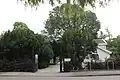 Exeter elm (background), De Iepenhof [: elmcourt] cemetery, Hoofddorp, Netherlands (2016)[15]
