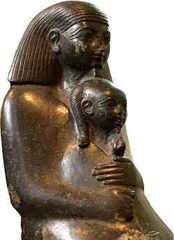 Seated Senenmut holding the princess Neferure in his arms, on display at the British Museum.
