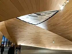 Wooden lobby with metallic sculpture in the ceiling