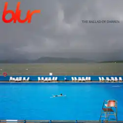 A photo of a swimming pool with a single swimmer surrounded by several chairs with the river Clyde and mountains in the background.