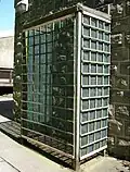 Safety cage around entrance to indoor hive (now dismantled)