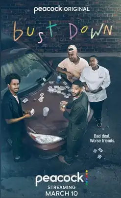 The image shows the four lead characters playing cards on the hood of a car in their work uniforms. They are peering up towards the sky directly at the camera.