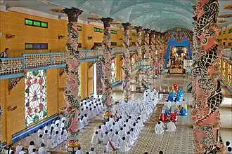 Cao Dai followers doing worship in the Holy See Temple