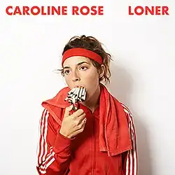 Caroline Rose wearing a red tracksuit, sweatband and towel, with two dozen cigarettes in her mouth