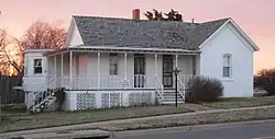 One-story frame house with wraparound front porch
