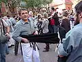 Casteller putting on a faixa (enfaixant-se)