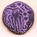 A copper coin of Rajaraja Chola with a Tiger besides the human figure