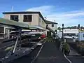 view of club from parking lot with fully loaded boat trailer in front