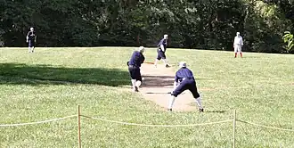 Men playing baseball in vintage uniforms