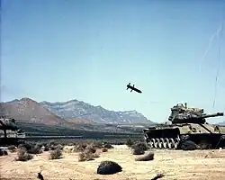 M712 Copperhead, a laser guided artillery shell, approaches a target tank