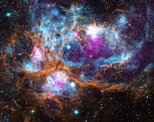 Image 4 NGC&nbsp;6357 Photograph credit: NASA NGC&nbsp;6357 is a diffuse nebula in the constellation Scorpius. This composite image of the nebula contains X-ray data from the Chandra X-ray Observatory and the ROSAT telescope (purple), infrared data from the Spitzer Space Telescope (orange), and optical data from the SuperCosmos Sky Survey (blue). Radiation from hot, young stars is energizing the cooler gas in the clouds that surround them. Often known as the Lobster Nebula, the astronomical object has also been termed the Madokami Nebula by fans of the anime Madoka Magica due to its supposed resemblance to the main character. Scientists at the Midcourse Space Experiment prefer the name War and Peace Nebula, because the bright, western part resembles a dove, while the eastern part looks like a skull in infrared images. More selected pictures