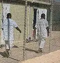 Detainees walk in an exercise yard in Camp 4.