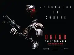 A futuristic police officer in armour and a helmet holding a gun is almost submerged from darkness. Behind him is the tagline "Judgment Is Coming".