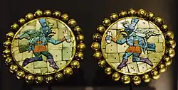 Earplugs of gold inlaid with precious stones