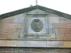 The Montgomerie family crest on the offices/stables/coach house