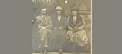 Elizabeth sitting in between a man and a woman
