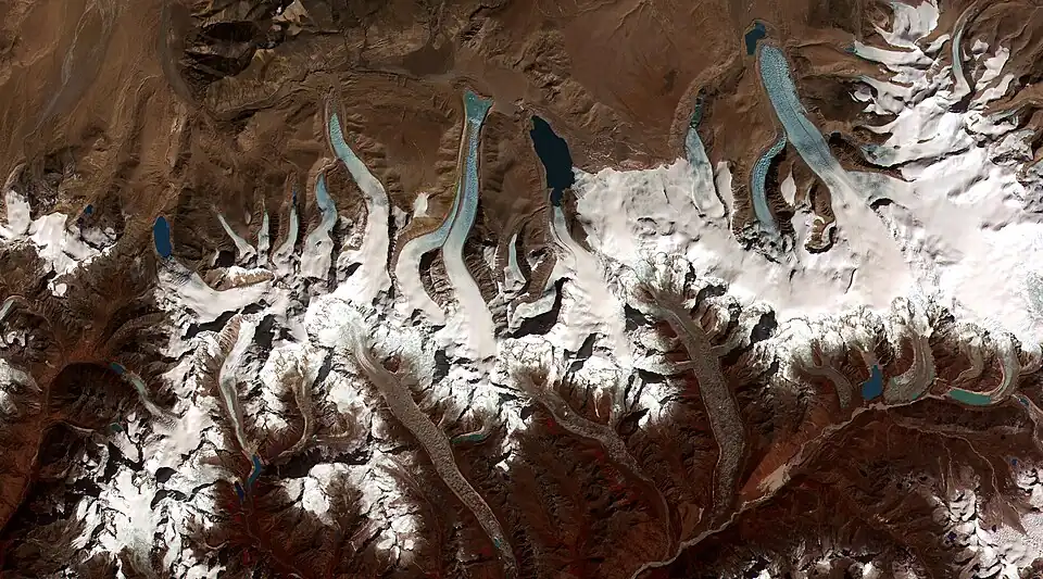 Image 44Glacier retreat is a type of glacial motion in which more material ablates from its terminus of the glacier than is replenished by flow into that region. In this region of the Bhutan-Himalaya, glacial lakes have been rapidly forming on the surface of the debris-covered glaciers and researchers have found a strong correlation between increasing temperatures and glacial retreat. (Credit: NASA & USGS.) (from Portal:Earth sciences/Selected pictures)