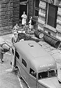 A patient being placed in an ambulance at Guy's Hospital, London. An AAGB member can be seen on the left, 1941.